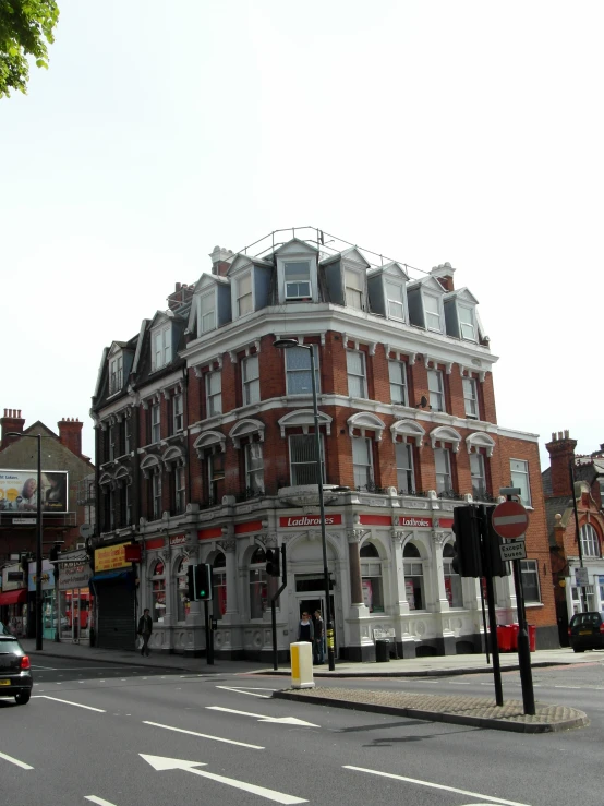 a very large brick building on a busy road