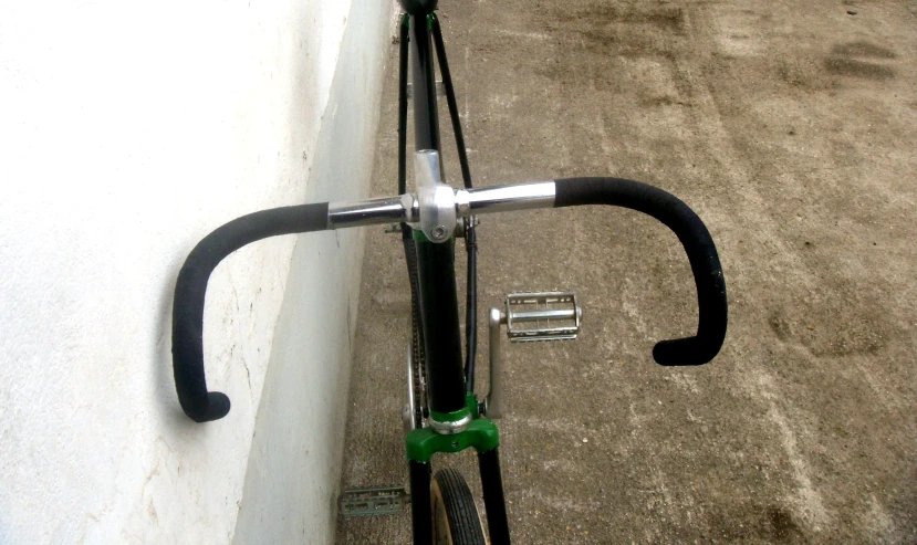 a bike with black seat and handlebars parked in the parking lot