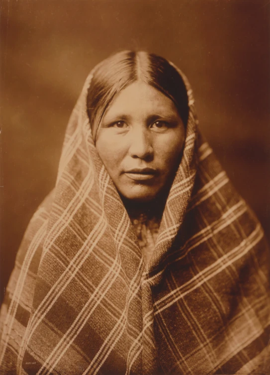 a black and white po of a woman with a plaid scarf