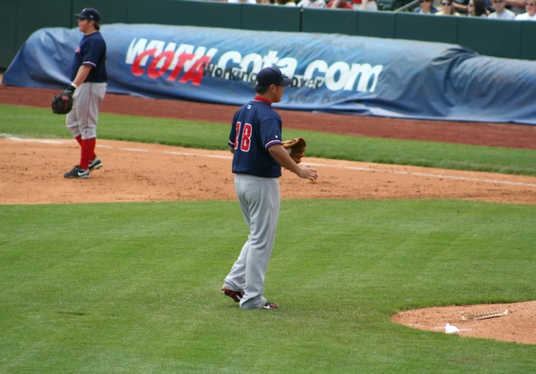 the professional baseball player is standing on the field