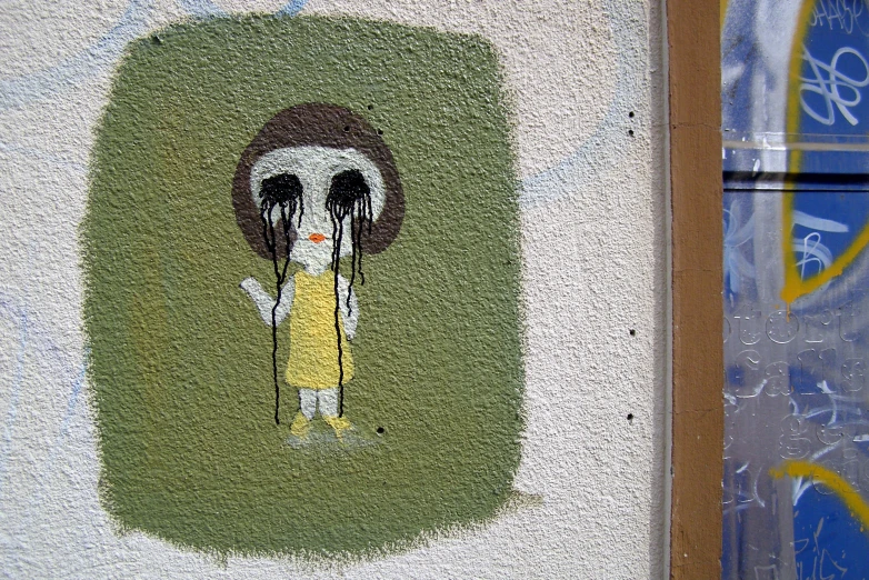 a cartoon picture on the side of a wall with a yellow dress