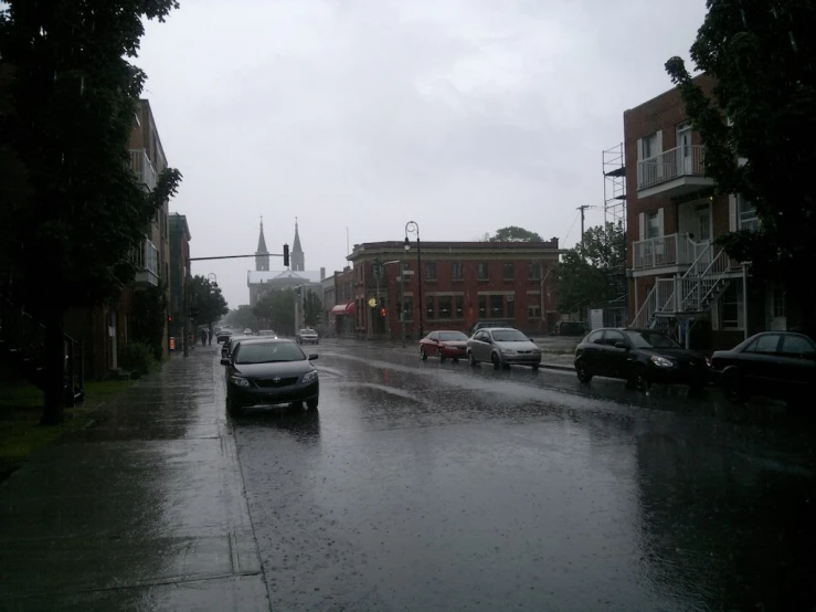 the street is littered with lots of traffic and rain