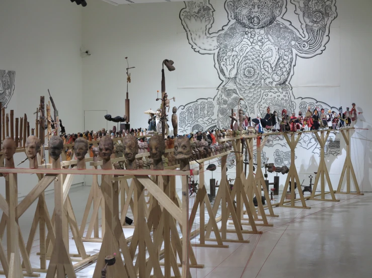 a large room filled with wooden slatted frames and sculptures