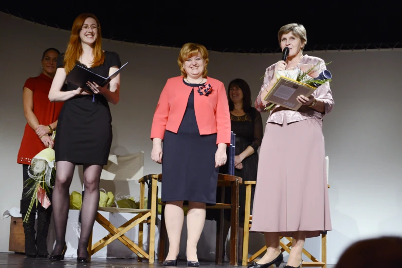 two woman who are standing on stage