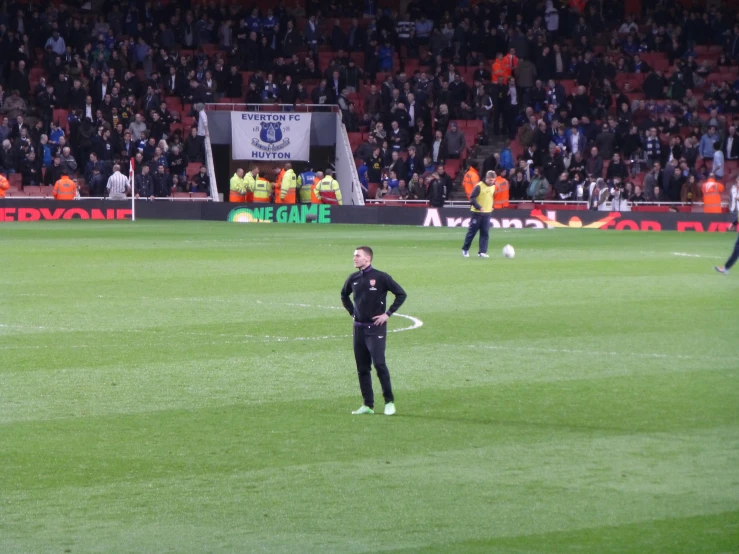 an athletic team on a field in front of spectators