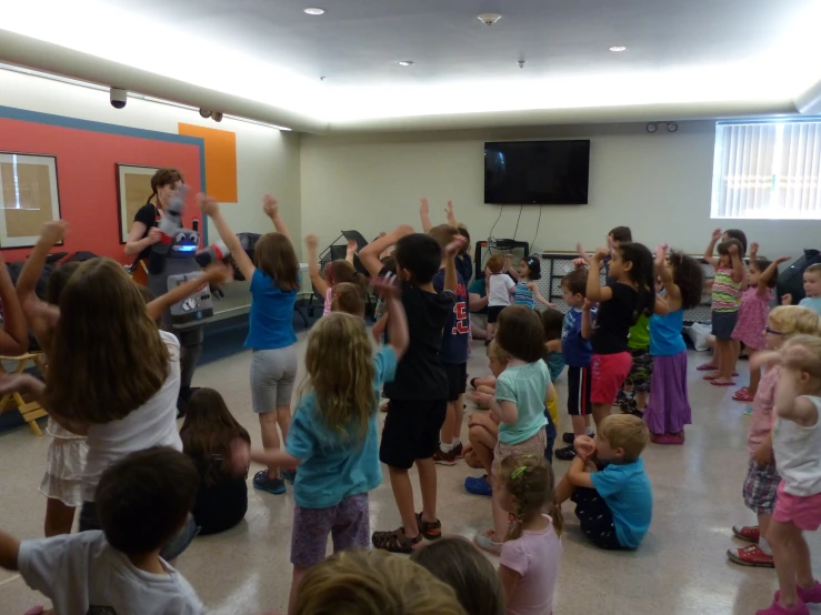 an audience of young children standing and sitting around each other