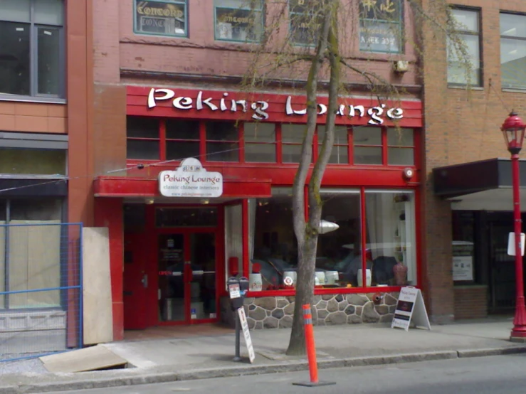 a building with red brick on the corner near street corner