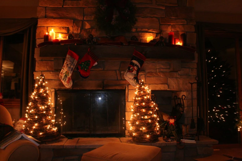 there is a fireplace with lights and stockings on it