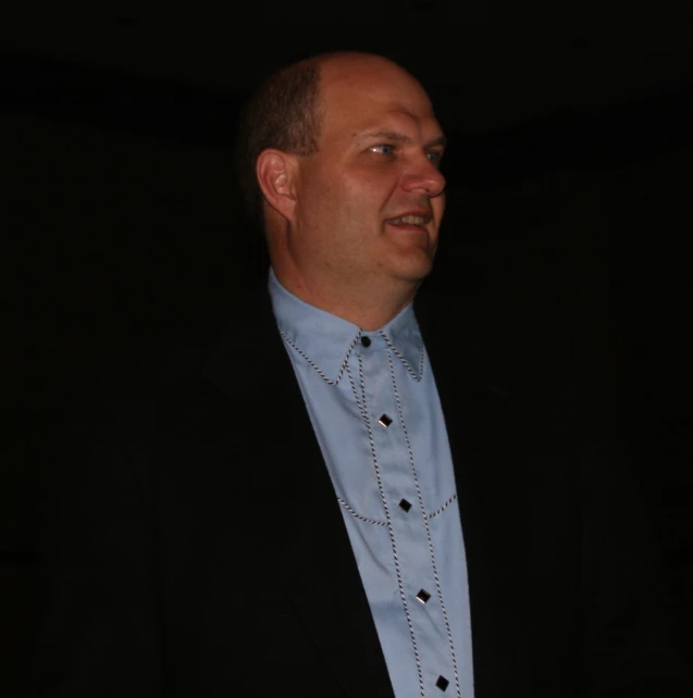 a man in a suit with black dots on his collar