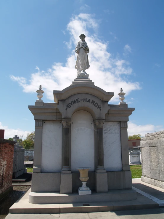 a statue sitting in the middle of a grave