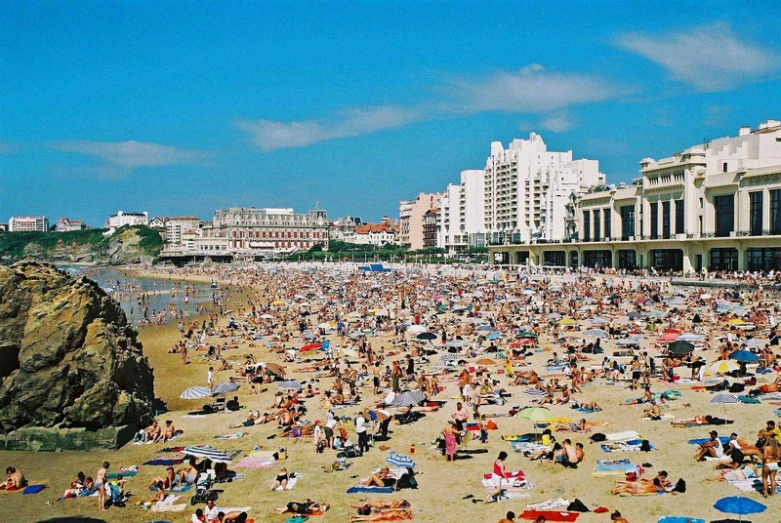 many people are relaxing and laying around on the beach