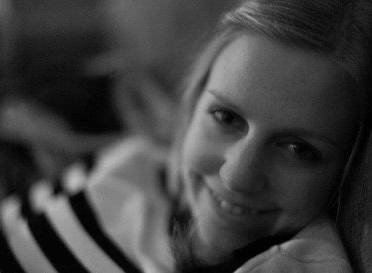 a woman that is smiling while looking out a window