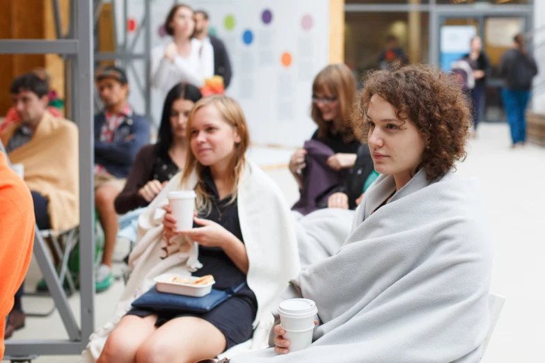 a group of people sitting outside on a bench