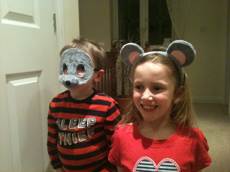 two s are wearing mouse ears and mickey mouse costumes