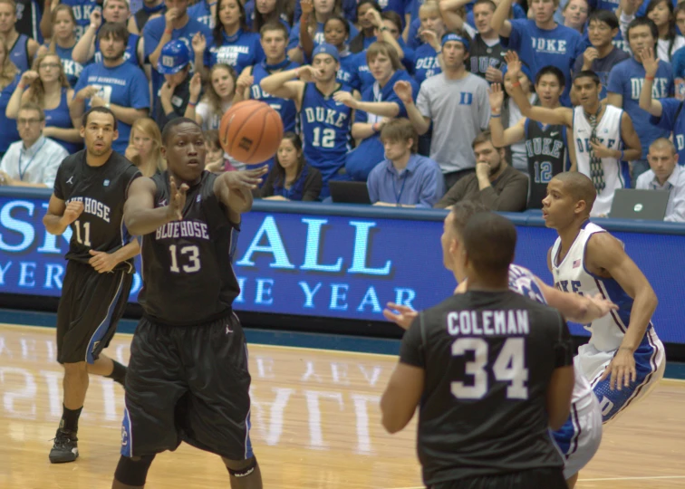 a basketball player with the ball above his head