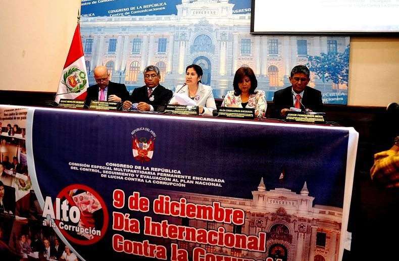 people sitting at a table during a press conference