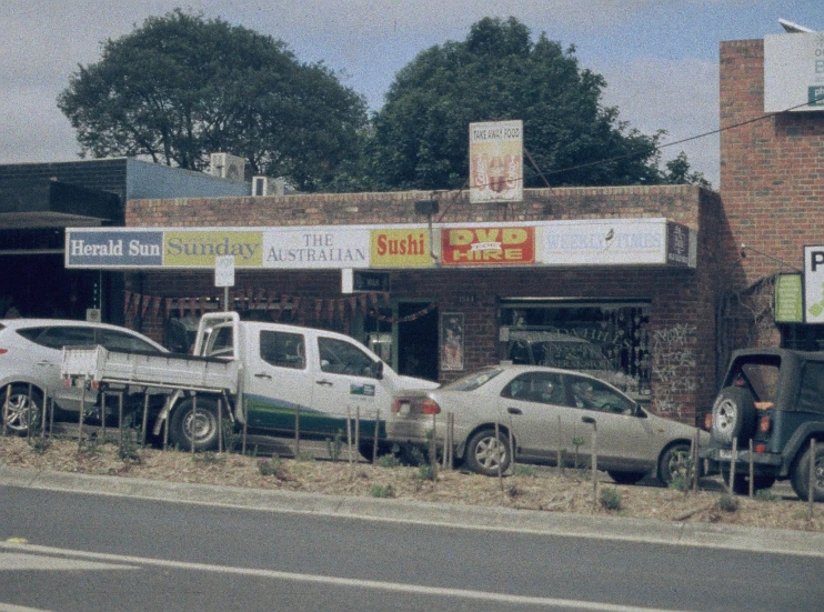 the cars are lined up on the curb in front of the building