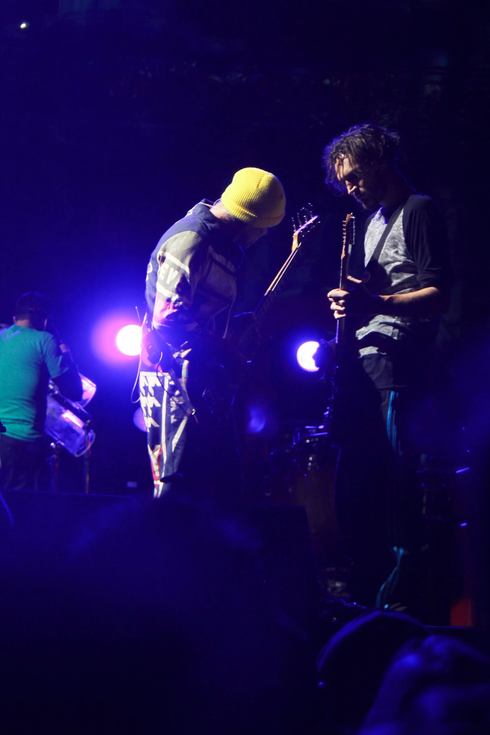 two people in the dark on stage singing