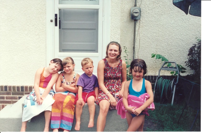 a group of children sitting on top of a step