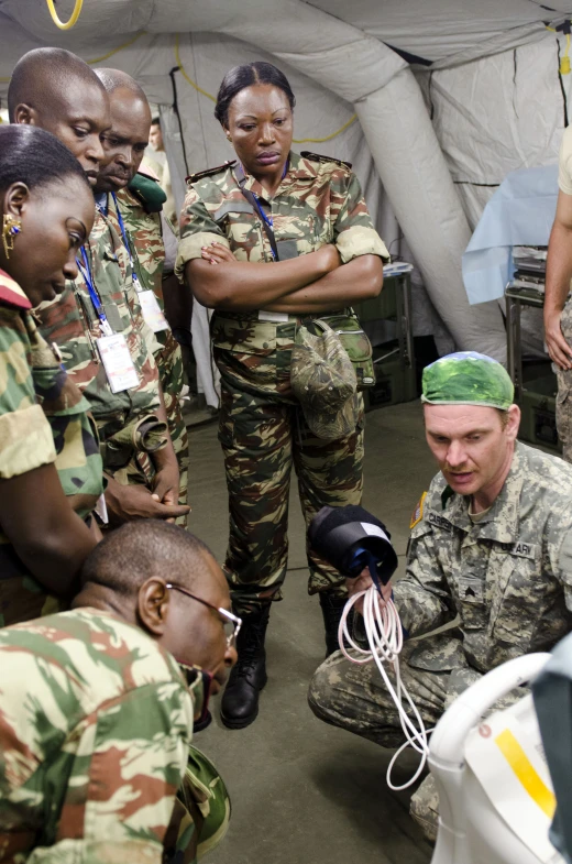 a group of soldiers are looking at some wires