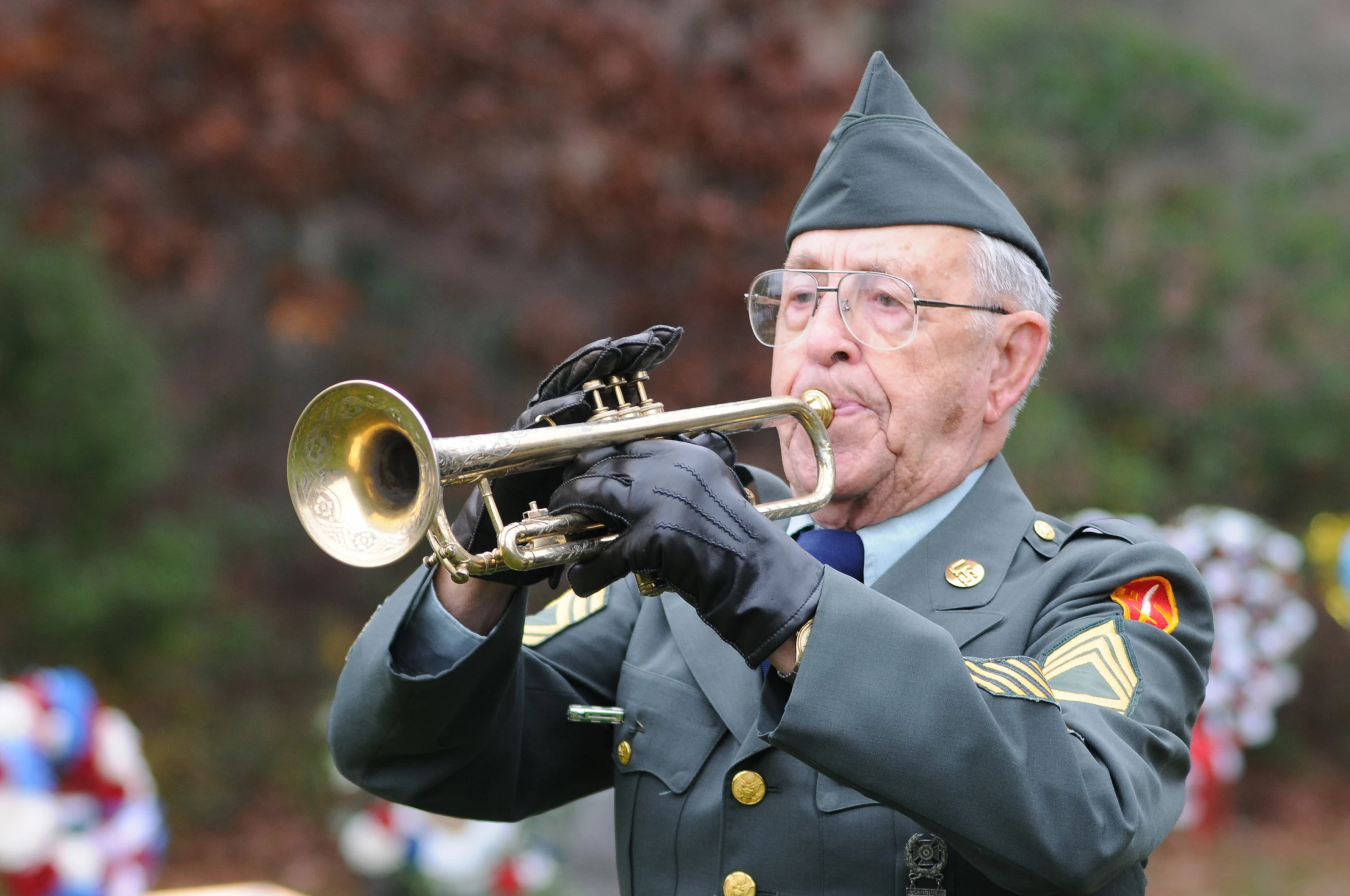 a man in an army uniform playing a trumpet