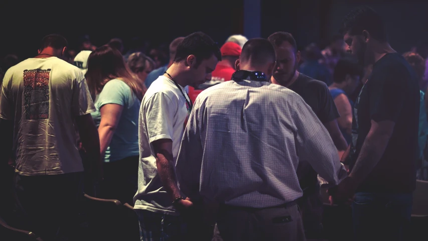 two men with ties standing in a crowd