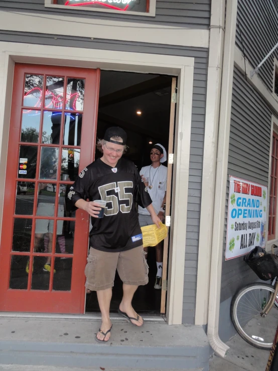 a boy stands outside the door of a store