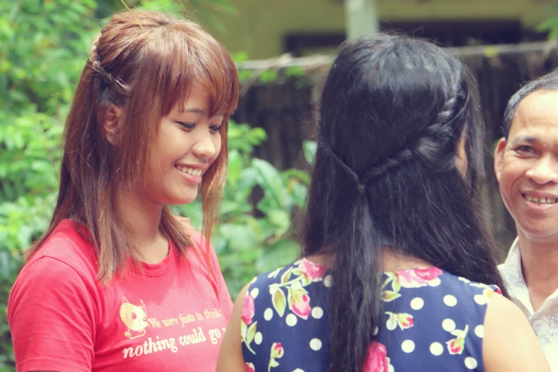 a man and two women smile for the camera