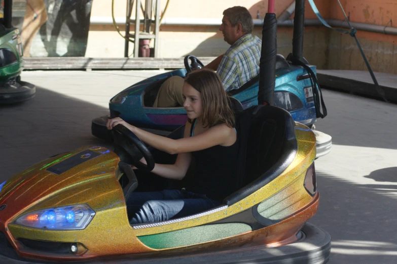 a  rides on a brightly painted bumper car