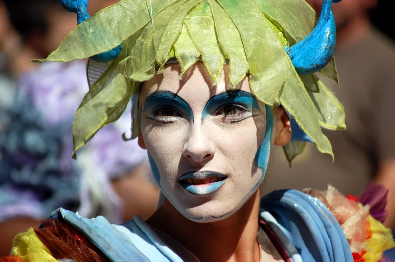 a male wearing a blue and green costume