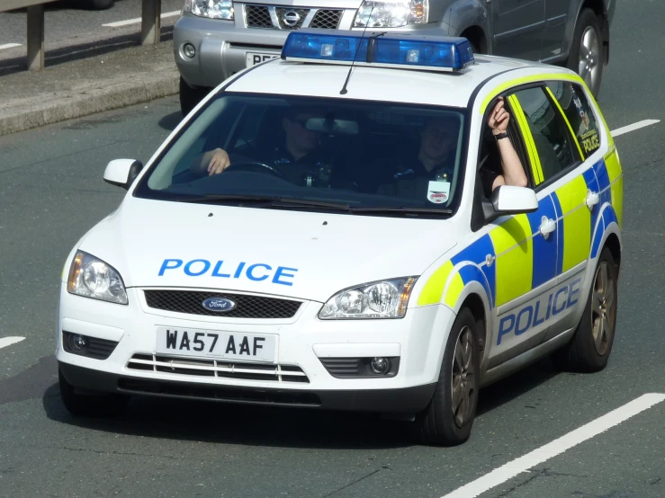 an image of police car driving on street