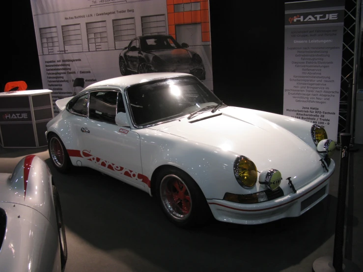 an all white porsche gt3 type car on display