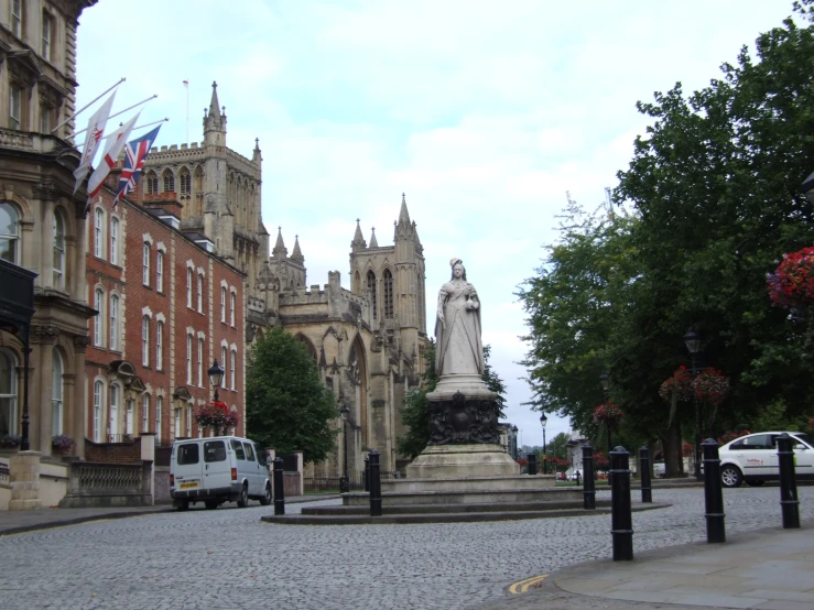 a street scene with a statue and car