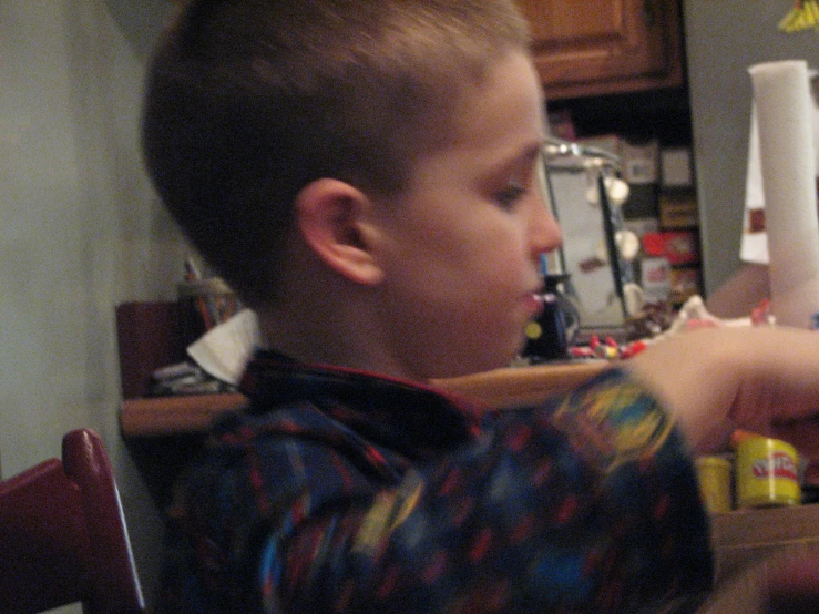 a little boy playing a game with remote controllers