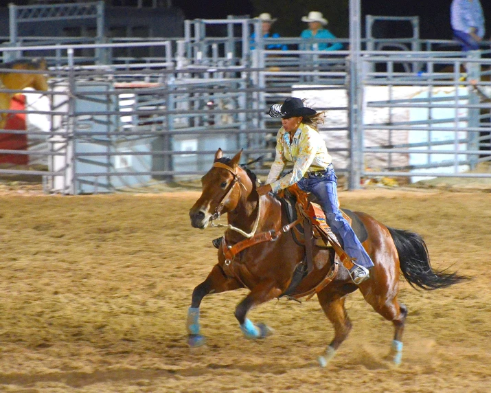 a woman riding on the back of a brown horse