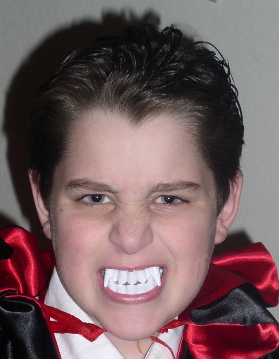 a person dressed as dracula with a fake smile