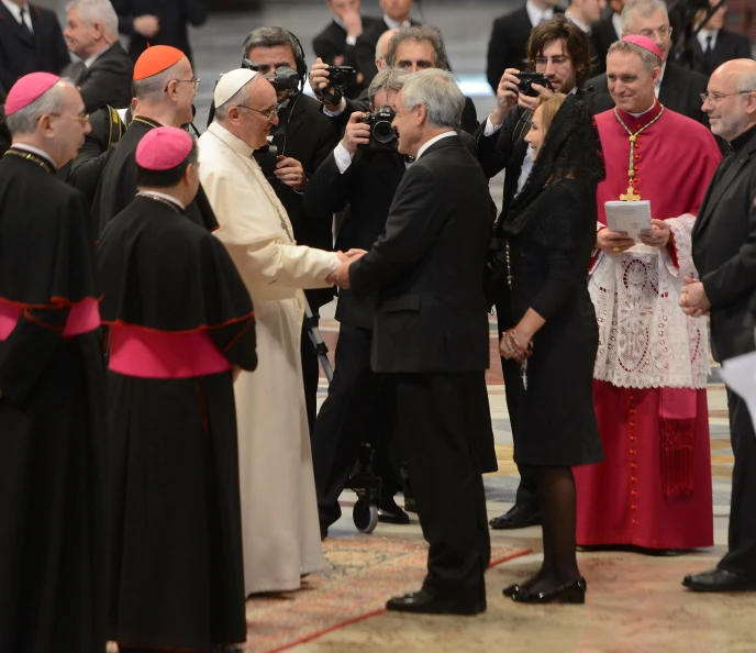 two men shaking hands in front of a crowd