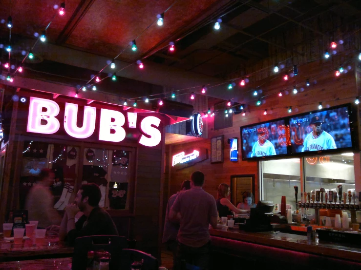 two people at a bar that has some lights