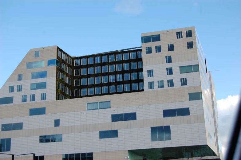 an outside view of a building with windows, and sky in the background