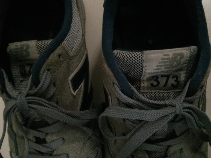 the bottom of a pair of shoes, with the white sneakers with a green and black logo