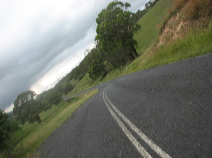 two white lines on the road going down hill