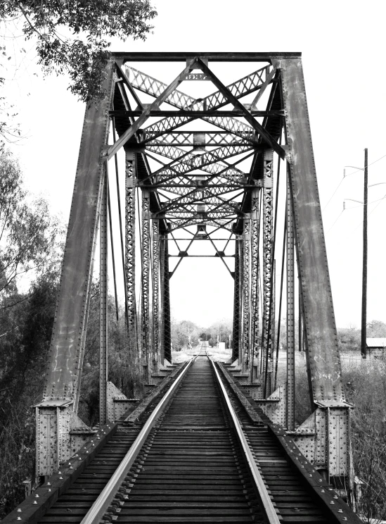 black and white pograph of train tracks passing through the middle of nowhere