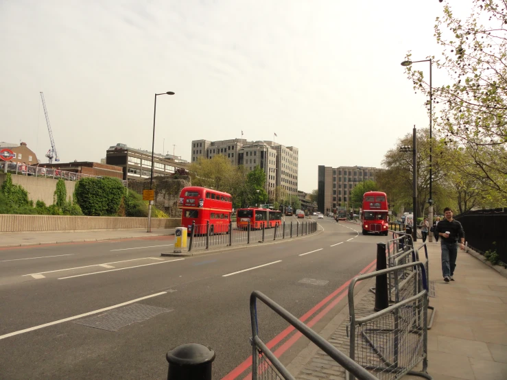 red double decker buses driving down a street