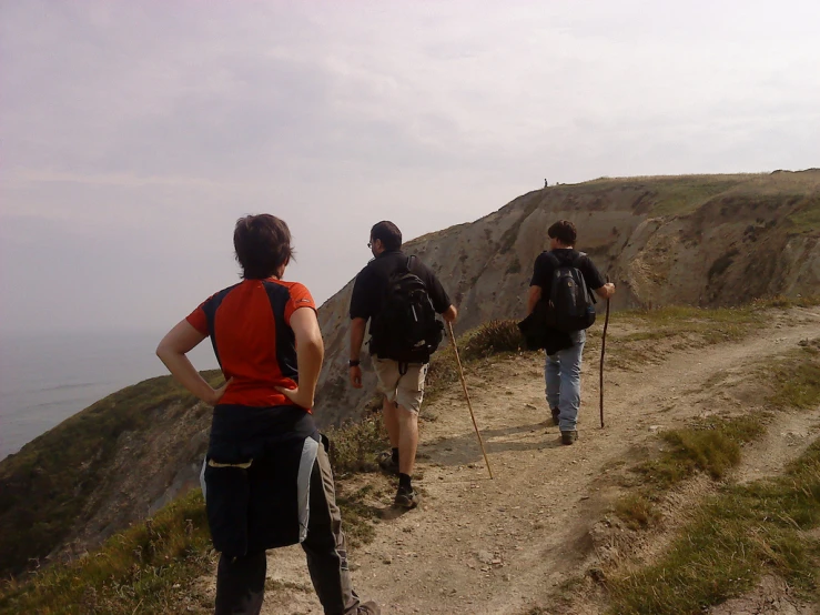 people hiking along a trail up a hill