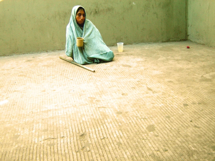 a person sitting on the floor with a mug of coffee