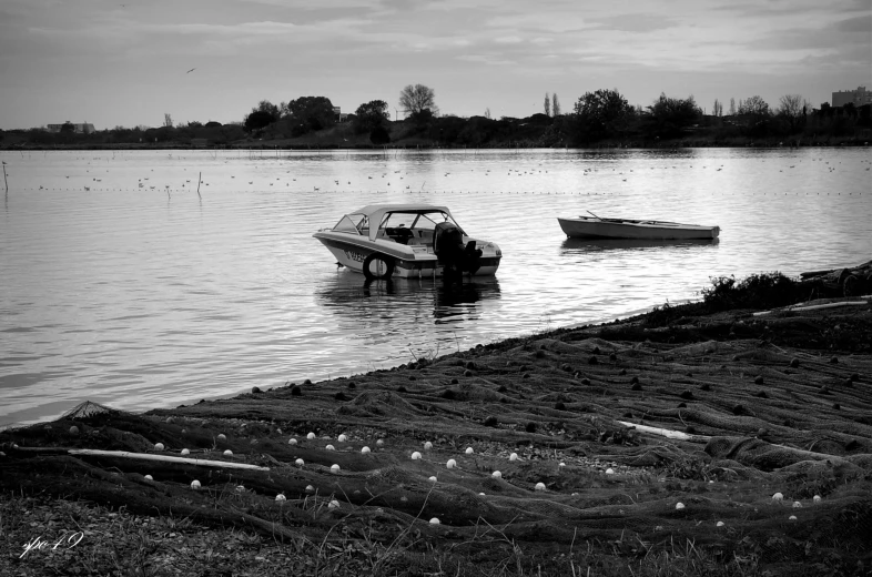 black and white po of a boat in a lake