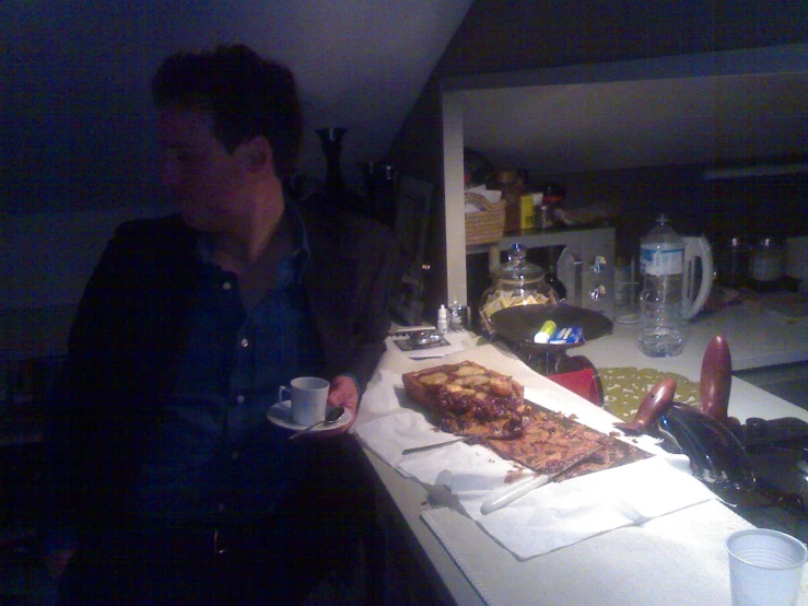 a man is sitting at the kitchen counter eating