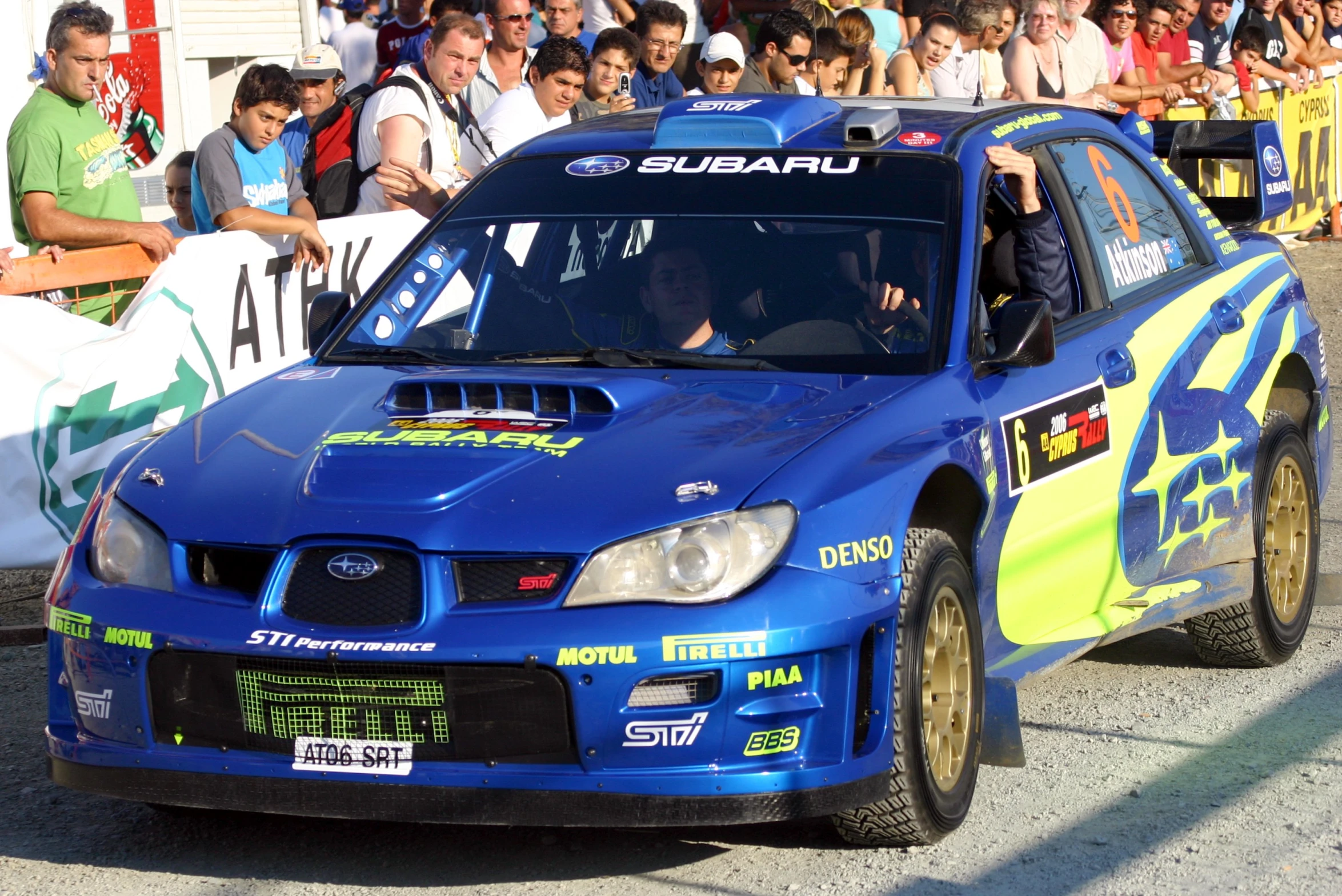 a subaru rally car making its way down the road