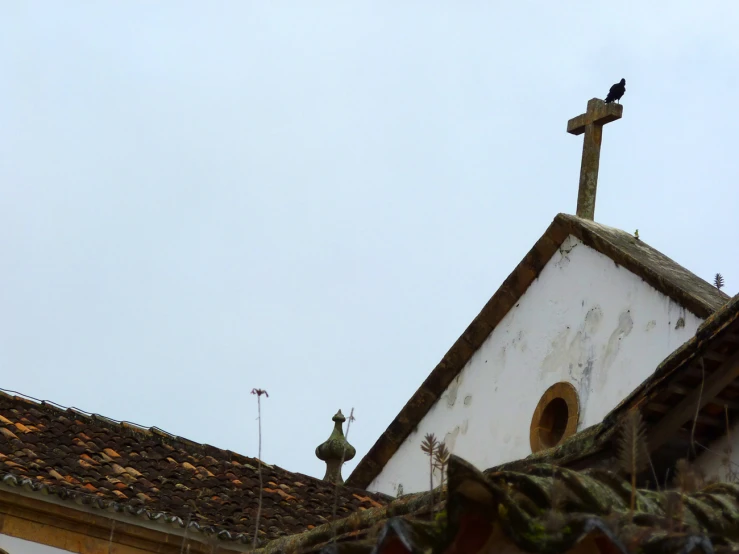 a very tall church building with a cross at the top