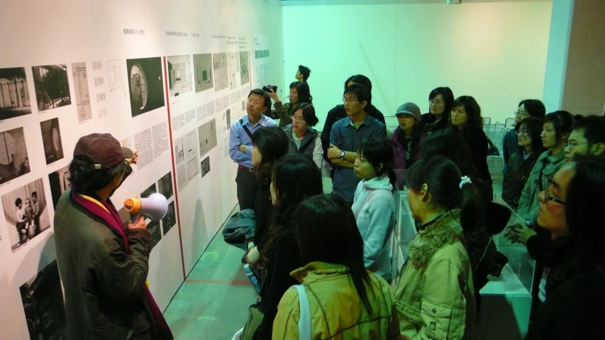 group of people gathered around at an art exhibit